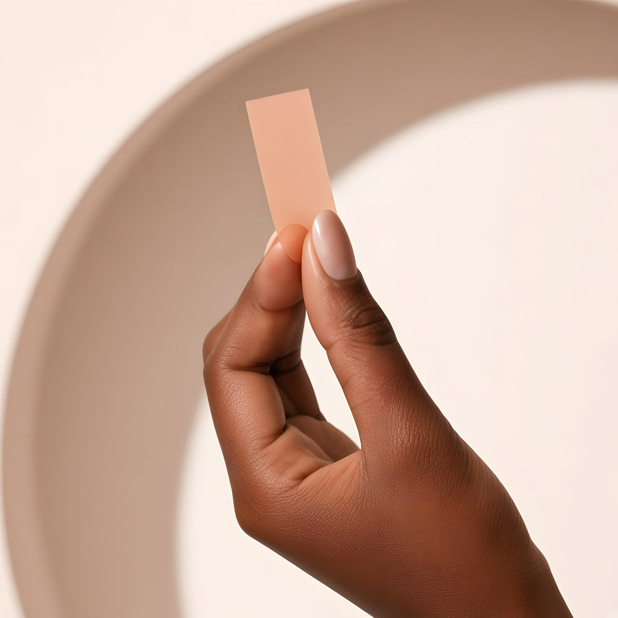 Hand holding a single oral strip